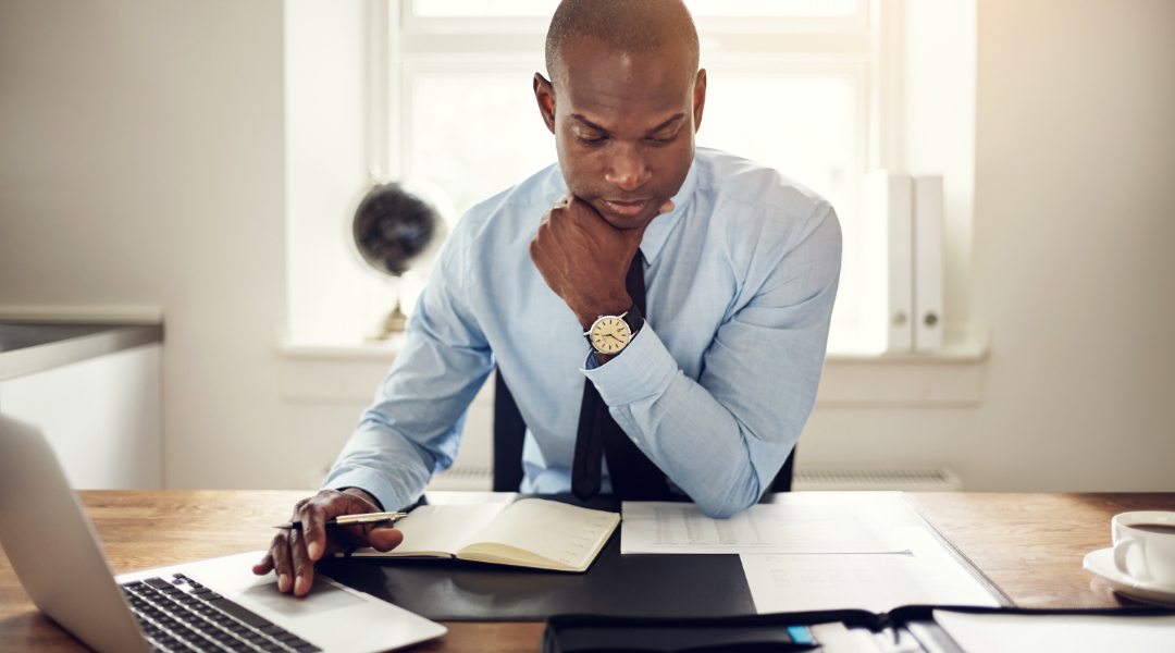 accountant looking at numbers and working on his laptop