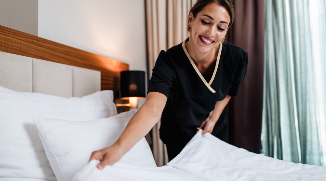 hotel housekeeper making a bed