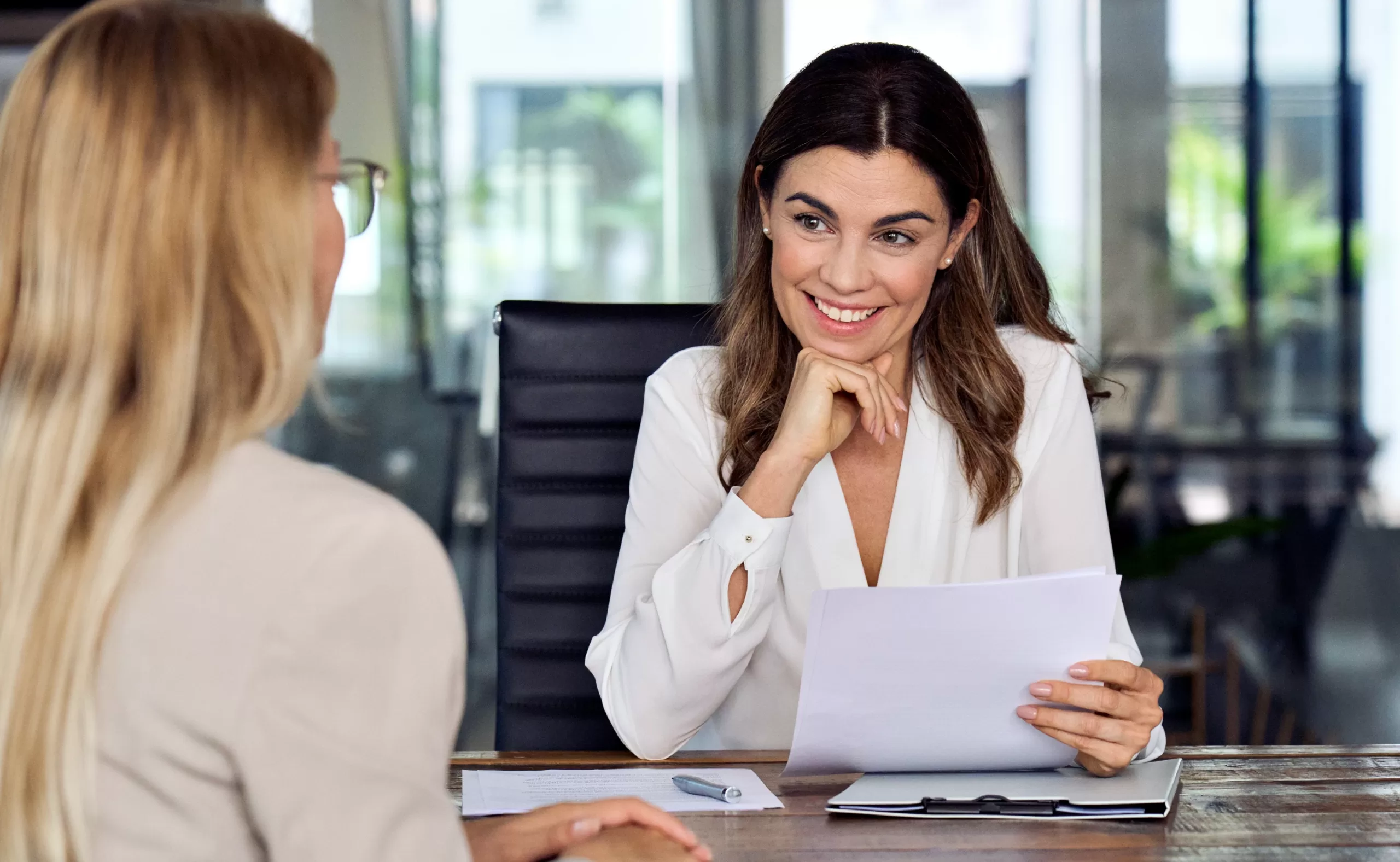 Women interviewing a female candidate for hotel staffing.