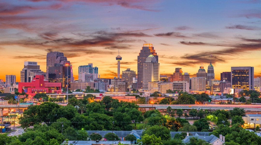 Photo of the San Antonio, TX skyline with a beautiful sky in the background.