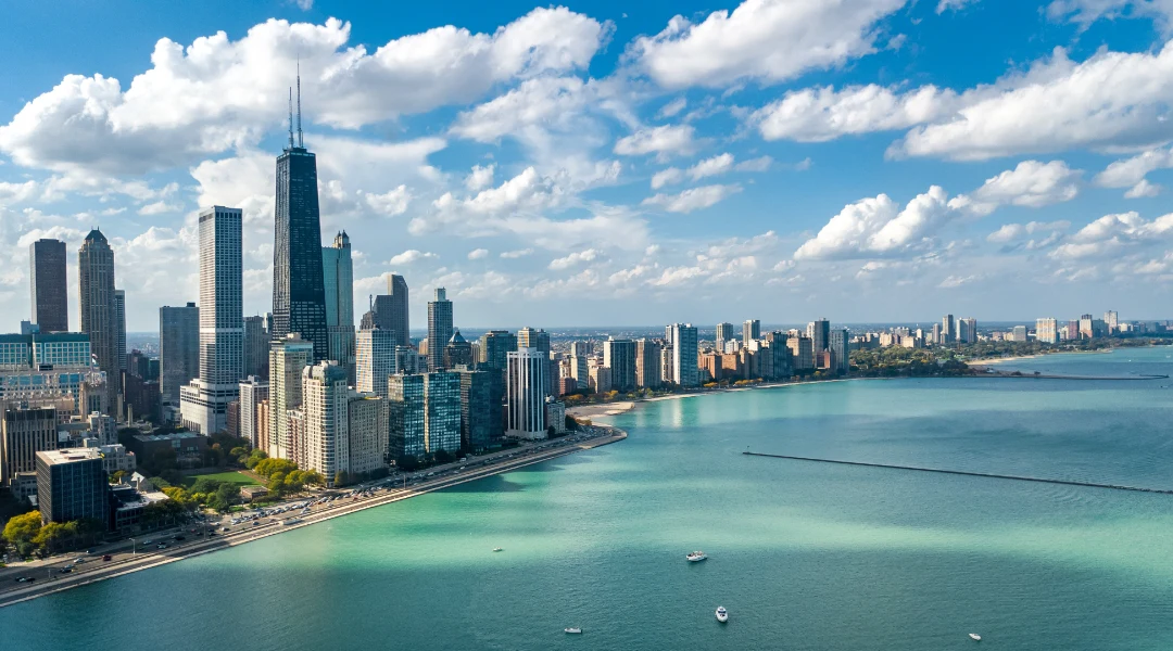 A landscape photo of the Chicago skyline against a cloudy blue sky.